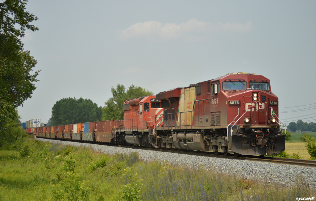 CP 8876 South blasts by South Yard Switch Spence cleared all the way to Begin/End CTC sign Bolton with the help of veteran SD40-2 #6011 and 120 platforms in tow. Interesting CP consists are still out there, you just have to know where and how to look!