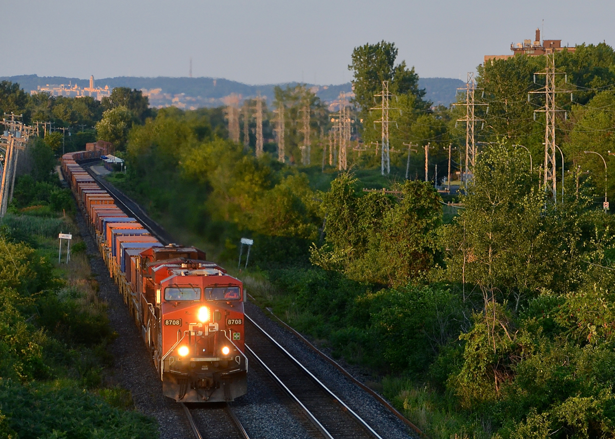 Leaving Montreal about 5 hours later than normal, CP 143 catches last light as it rounds a curve in Pointe-Claire, with the Pointe-Claire Station in the background and Mount-Royal further back. Power is CP 8708 & CP 9634.