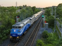 <b>Another paint scheme varation on the AMT.</b> Fresh from repaint and rebuild, AMT 1348 is in service with yet another AMT paint scheme variation. Tonight it was paired up with another ex-GO Transit F59PH, RBRX 18531, on the Vaudreuil-Hudson line. Here AMT 30 heads east after leaving Cedar Park station just before sunset. The signal at right is green for a very late CP 133.