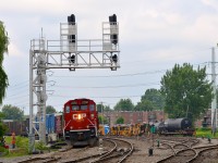 CP 2250 is passing a signal tower that had just been set up a few minute earlier. The older triple searchlight signal is still in place and in use, but its days are numbered. At right is CP's Lasalle yard.