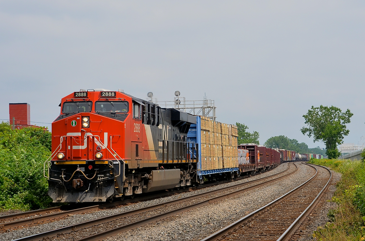 A late CN 369. CN 369 is through Dorval with 150 cars and CN 2888 at the head end and another ES44AC mid-train (CN 2870). It is passing through here about 5-6 hours later than normal due to the CN derailment on the Kingston sub on Saturday.