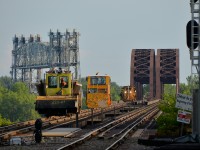 A track gang is leaving the island of Montreal and Lasalle Yard to work on the CP Seaway spur on the south shore. They are crossing the St-Lawrence river but will have to wait for the Seaway bridge at left to go back down before they can continue.