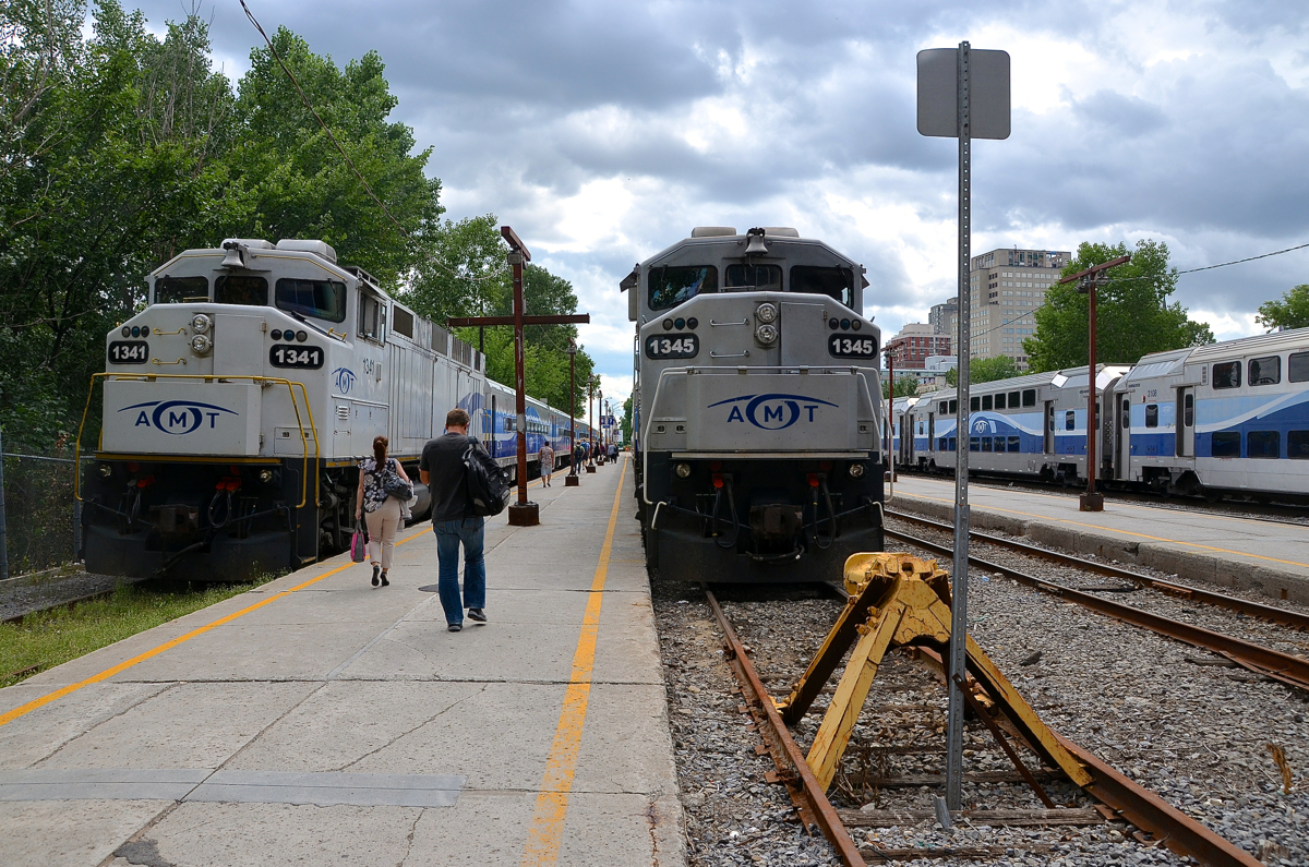 It's the start of the afternoon rush hour at Lucien L'Allier Station, with two Candiac trains lined up side by side, both with F59PH's for power (one white, the other grey). AMT 1341 at left will leave at 1540 with AMT 87 and AMT 1345 will leave 15 minutes later with AMT 89.