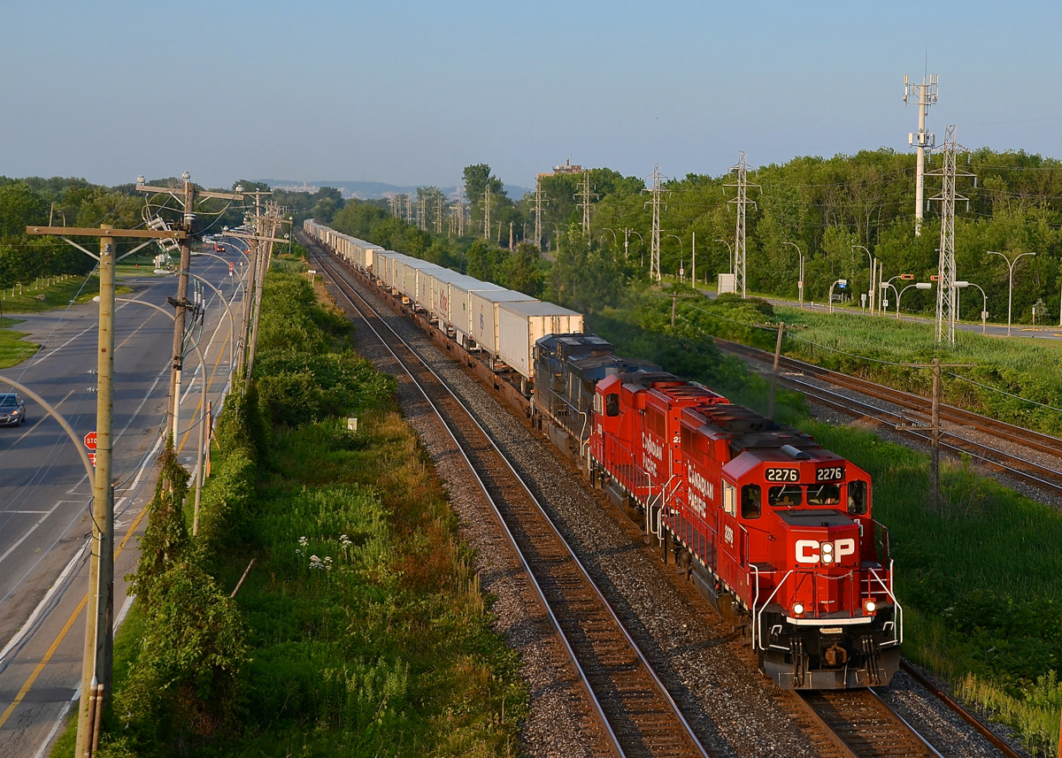 On the south track for a change, with a GP20C-ECO leading. CP 133 (the westbound Expressway, a dedicated piggyback train) normally operates on the north track of the Vaudreuil and Winchester sub. Today he was on the south track, allowing for a better view of the engines than normally at this location. An interesting lashup of two GP20C-ECO's and a CEFX AC4400CW (CP 2276, CP 2250 & CEFX 1058) leads CP 133 through Pointe-Claire on a sunny summer evening.