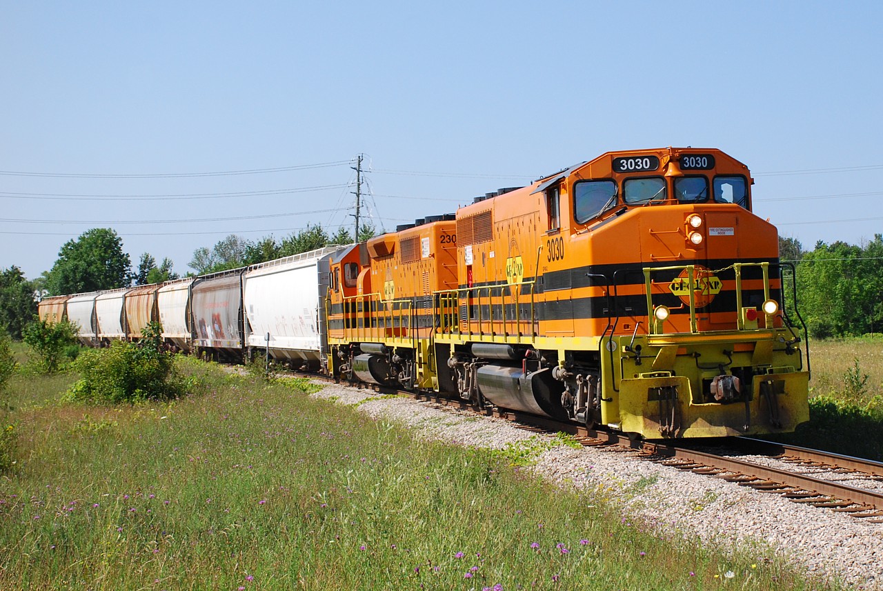 GEXR 581 approaches the Hwy. 8 crossing as it slowly rolls in to Goderich with a short train.  The first hopper would be set off on one of the sidings where they once loaded graders, and the remaining six cars were taking down to the salt mine.  The second hopper was hauled back up, so it must have been for an elevator with an east facing switch that would be set off on the return to Stratford.