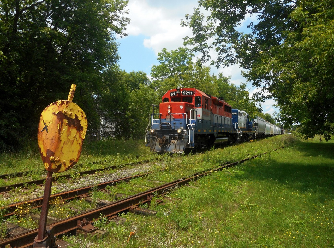 580 rolls south on the Guelph North Spur, past the old XV3 switchstand, just before Alma Street on it's return trip to Kitchener.  The train waited for 431, led by 3054 and 3393 to pass.