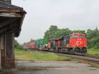 The rain has just stopped as a pair of ACs 2876 & 2935 pass the disused shell of the old station. It is a crime that this relic of the past has been allowed to get into such a state!