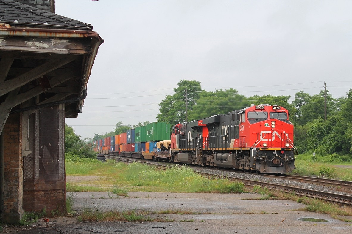 The rain has just stopped as a pair of ACs 2876 & 2935 pass the disused shell of the old station. It is a crime that this relic of the past has been allowed to get into such a state!