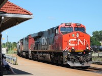 CN 2803 and 2429 heading east leading a mixed freight through the station.