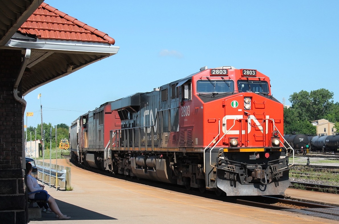 CN 2803 and 2429 heading east leading a mixed freight through the station.