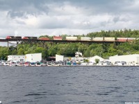 Train Q10531 with 2556 leading Illinois Central 1036 (in CN paint) as it passes over the Parry Sound trestle in town with the Canada Day festival happening in town. The trestle was built in 1907 and spans the 517m gap over the Seguin River 32m high.