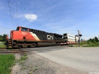 Intermodal train Q10721, a daily Montreal, Quebec to Winnipeg Manitoba train passes by the Ramara Rd grade crossing doing just under 40mp/h with only the ES44DC to handle the train. Q10721 had met its counterpart, Q10651, which runs from Robert's Bank, British Columbia to Montreal, Quebec at Quaker, a location about 40 miles south of where the photo was taken.