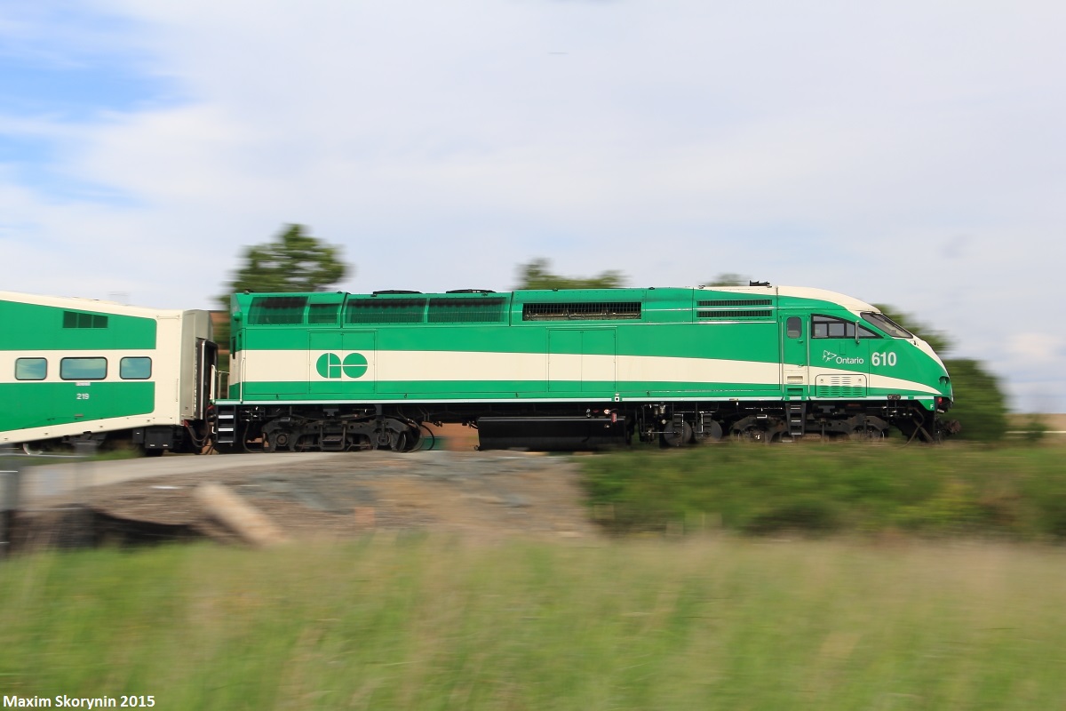 Northbound GO train #805 charges past the Langstaff Rd crossing, with MPI MP40PH-3C locomotive #610 pushing on the tail end at mile 15.10 of the CN Newmarket Subdivision. The Newmarket Subdivision used to be owned by the Canadian National Railway Company, but GO Transit had purchased the line. However, CN still operates the line while GO Transit owns it, with about 1 freight train each day which usually runs during the night to avoid distributions with GO train's. Construction has started of a 2nd track all the way to Barrie to run hourly service, which is scheduled to be completed by 2020.