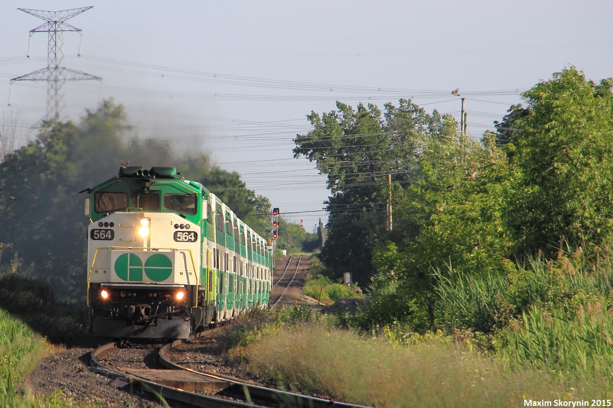 Northbound GO Train #811, the 2nd last evening downtown Toronto - Barrie commuter train approaches Rivermede Road at mile 14 of the CN Newmarket Subdivision with a rare L10L consist - a F59PH locomotive on the head end with a MP40PH-3C on the tail. The leading F59PH is one of the only 4 or 5 left on GO's fleet, and having 2 different engines on one GO train is hard to come across in 2015. The Newmarket Subdivision used to be owned by the Canadian National Railway Company, and later, GO Transit had purchased the line. However, it is still operated by CN. GO Transit also started construction of a 2nd track all the way to Barrie to run hourly service in the future, which is planned to be completed by 2020.