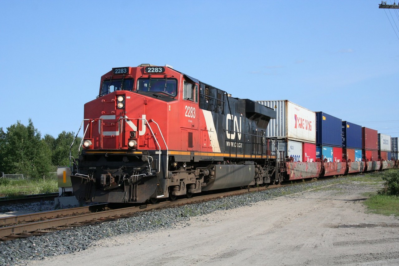 CN hotshot intermodal train no. 101 slows to a stop at Hornepayne for a crew change. ES44DC 2283 is backed up by distributed power units ES44DC 2331 in the mid-train position and C44-9CW 2671 on the tail end. Total train length was approximately 190 platforms.