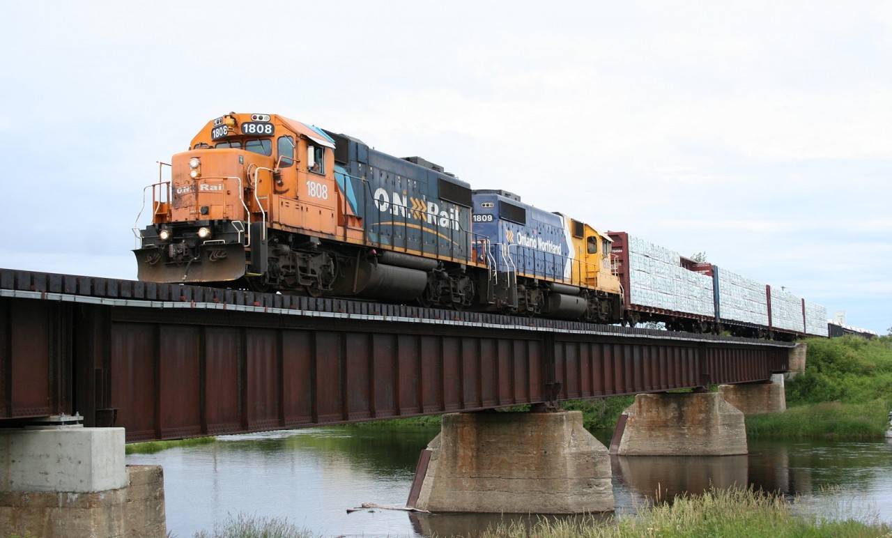 Ontario Northland train no. 516 (Hearst to Kapuskasing) rolls across the Mattawishquia River bridge departing the French-Canadian town of Hearst with 9 cars bound for points south or east via Cochrane.