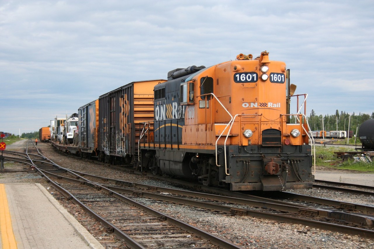 Ontario Northland's classic high-nose GP9 1601 pulls the afternoon yard duties at Cochrane. The cars it's currently switching will head north up to Moosonee later during the night/early morning and consist of an interesting mix of express boxcars and vehicles and "piggyback" trailers on flatcars, as there is no permanent road connecting Moosonee and the south.