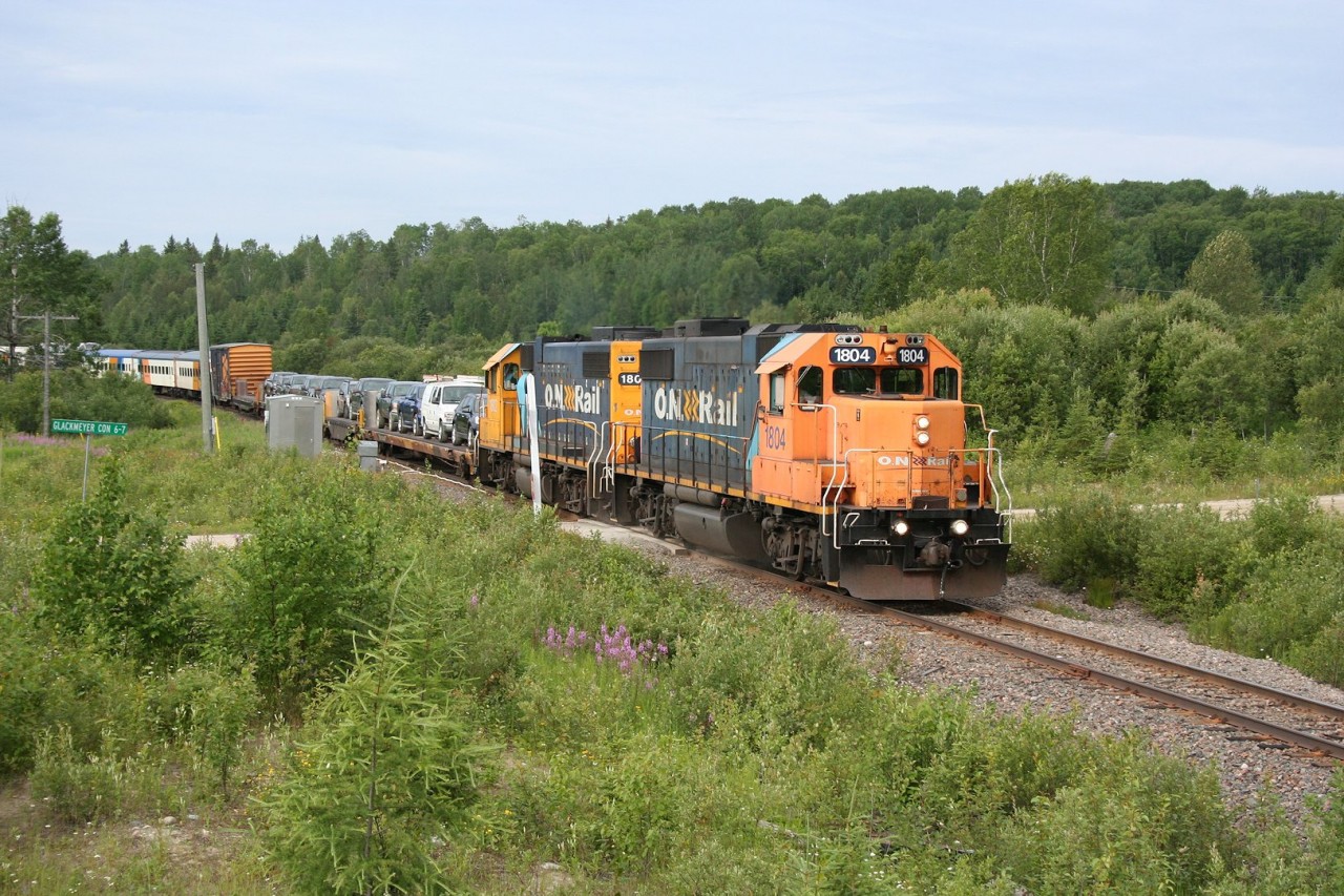 The northbound 'Polar Bear Express', Ontario Northland's unique tourist excursion/regular passenger service/mixed train approaches milepost 5.0 on the Island Falls subdivision on the beginning of it's daily trip to the remote community of Moosonee.