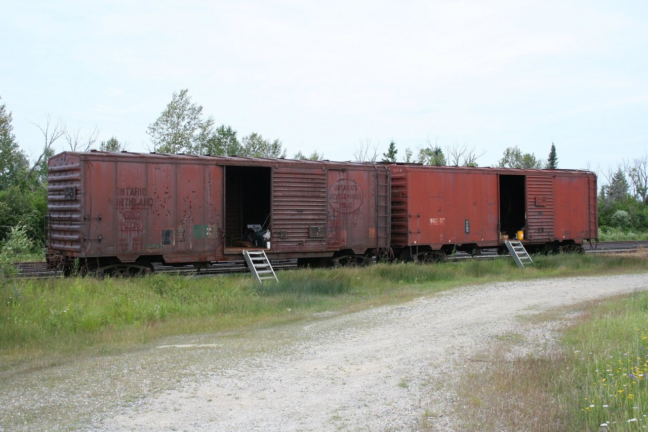 An all but extinct species on most railroads, the venerable old forty foot boxcar can still occasionally be found in work service. Ontario Northland actually still operates a number of old boxcars in company service, so when visiting this railroad it's not too hard to see at least a few, even if at a distance.

This pair of material storage cars were parked in the small yard at Porquis, the junction point where the lines to Timmins and Iroquois Falls diverge from the line up to Cochrane.