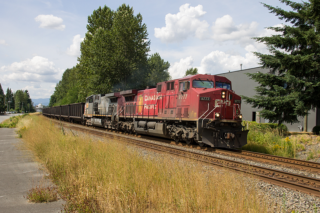 A movie star is caught leading an eastbound sulphur train through Albion, BC. CP 9777 was used in the movie Unstoppable and is seen with patched ex-SP AC4400CW 6419.