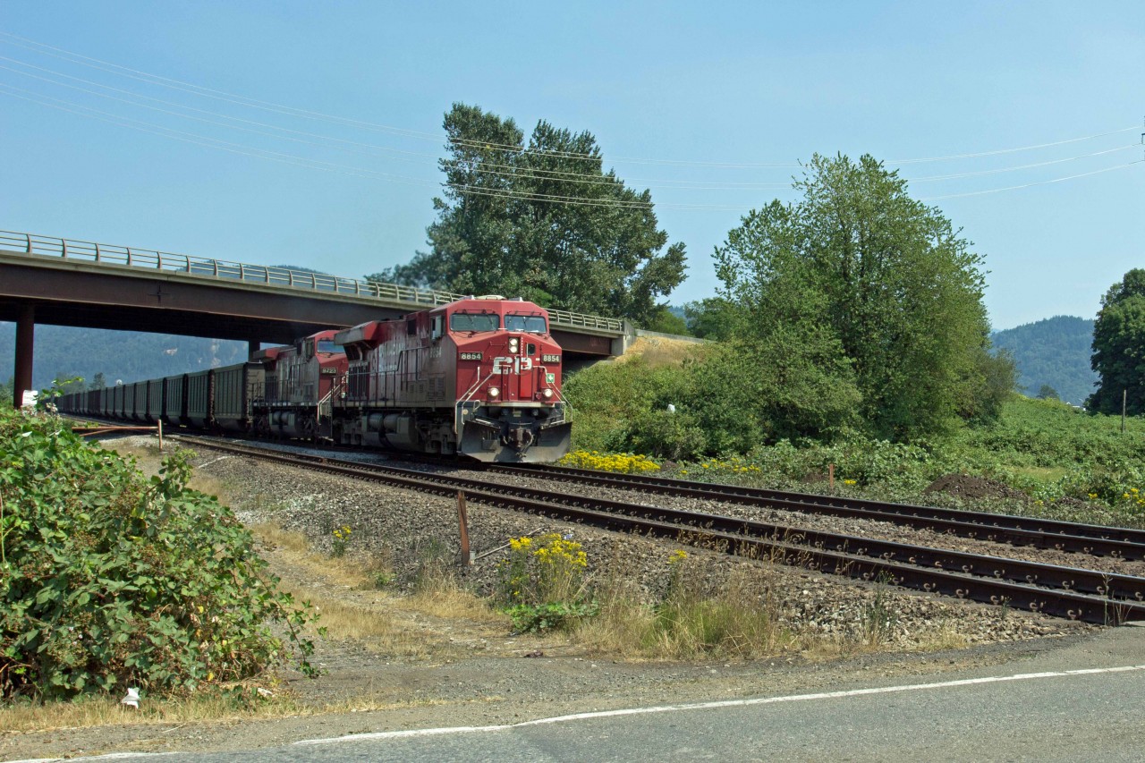 Westbound CP coal train passing under the south approach to Mission highway Bridge.