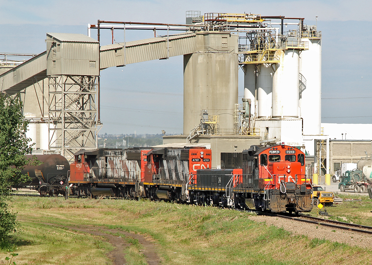 Switching cars into the Lafarge Plant at Clover Bar are GP9RM CN 7213, GP9 slug #240, and GP38-2(W)'s CN 4781 and 4767.