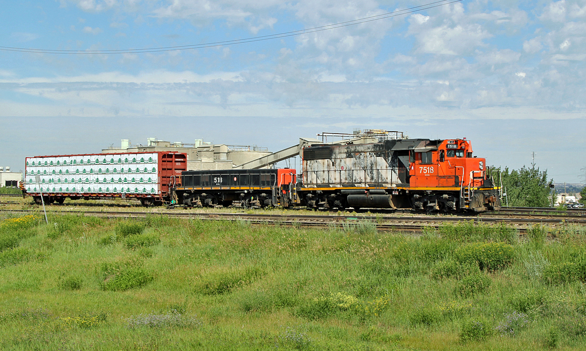 GP38-2 CN 7518 and HBU-4 #518 switch cars at the east end of CN's Clover Bar Yard.