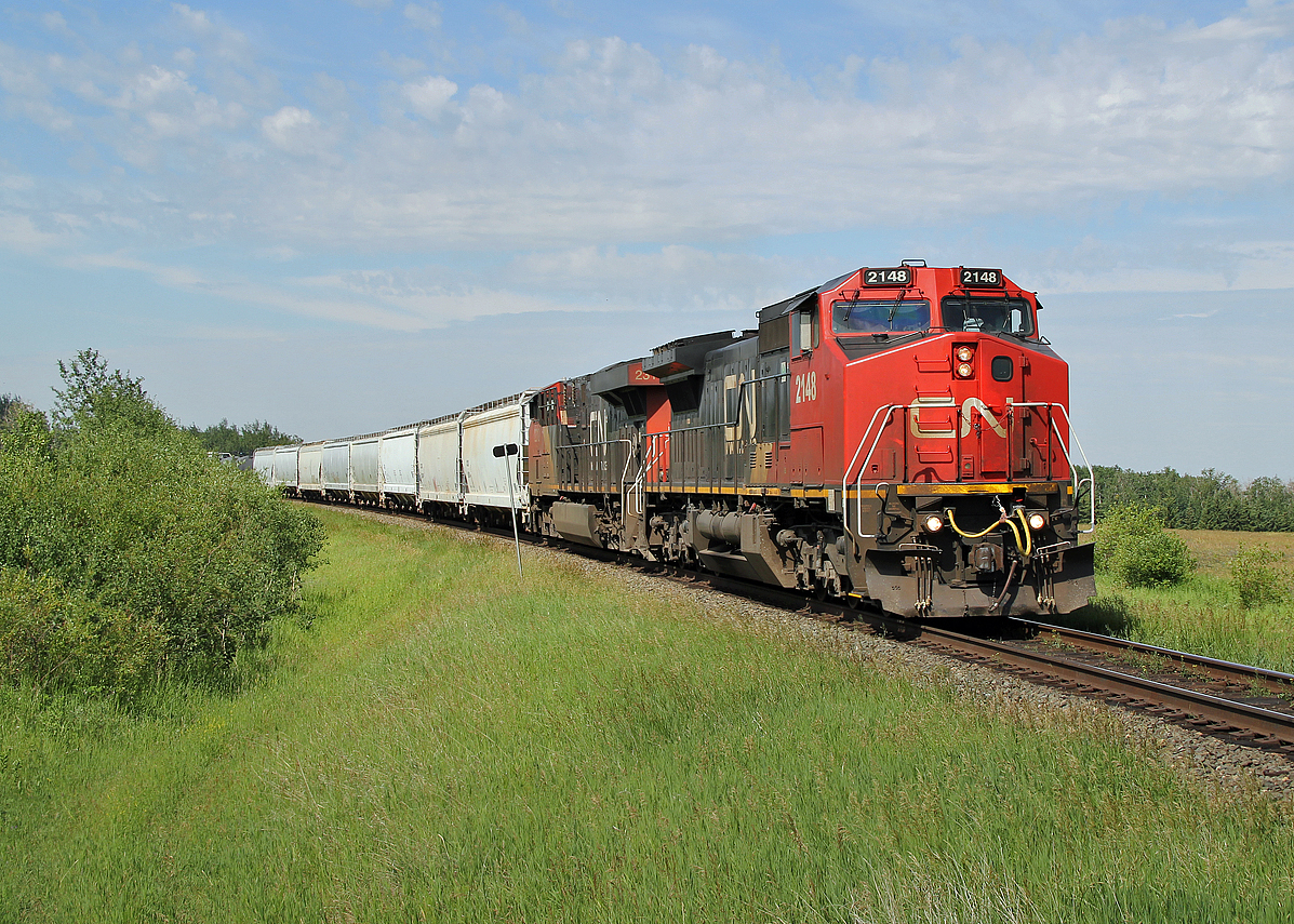 GE DASH 8-40CW CN 2148 and ES44DC CN 2310 head east near Ardrossan with a train from DOW Chemicals at Fort Saskatchewan to Toronto.