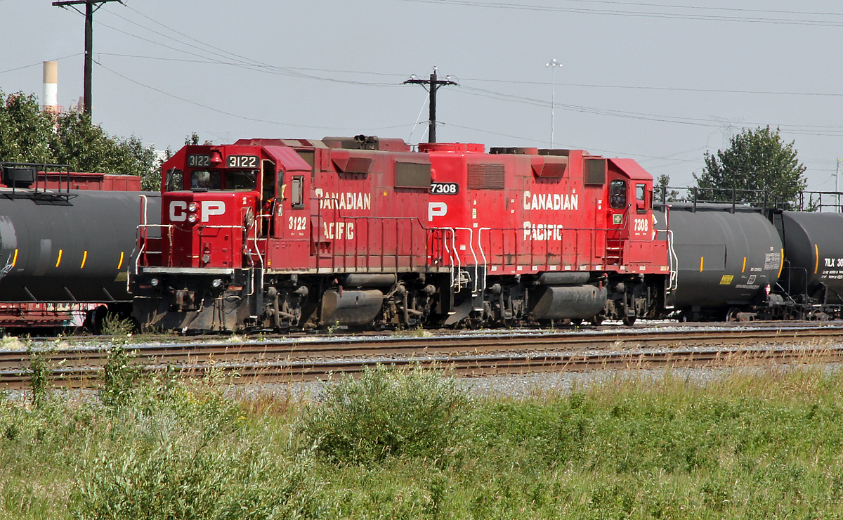 GP38-2's CP 3122 and 7308 (ex St. Lawrence & Hudson) roll into CP's Clover Bar Yard light engine to await there next assignment.