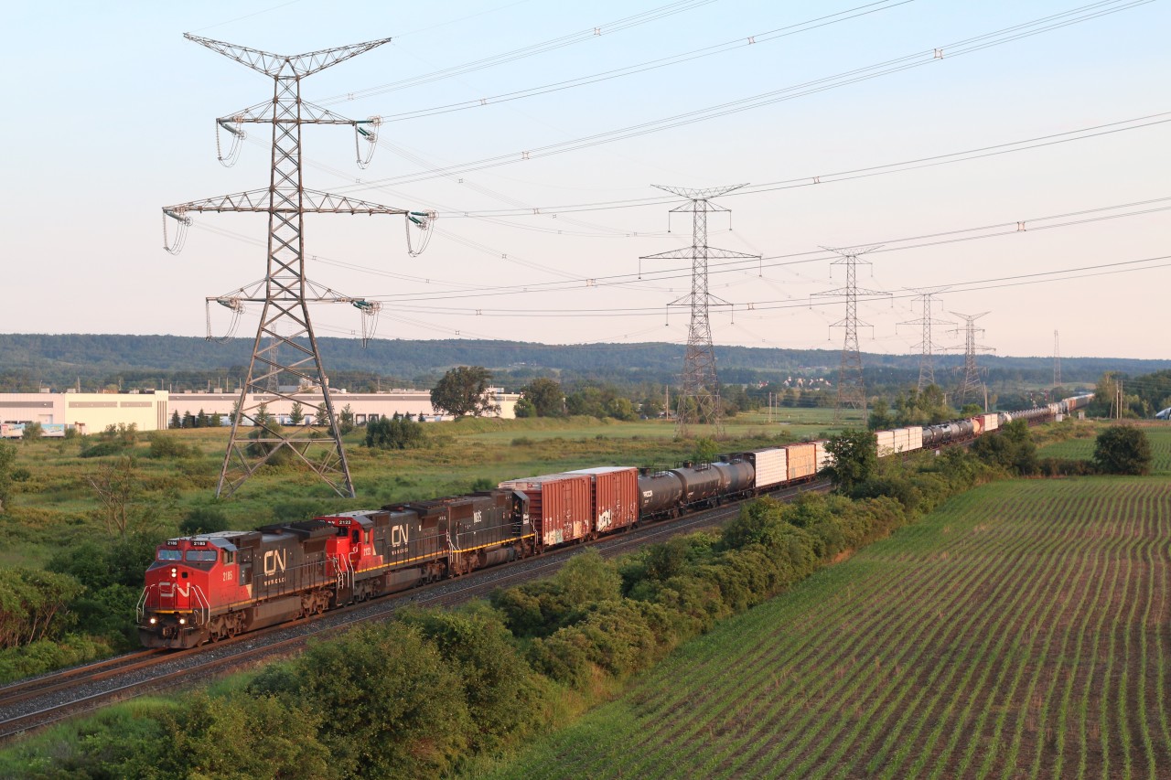 CN train 385 makes its typical early morning arrival at milton. Power today was former BNSF and UP Dash 8s ahead of an IC SD70. The Niagara Escarpment is in the background, and the tail end of the train is still at Scotch Block.