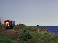 New Brunswick East Coast (former CP Rail) RS18u 1840 leads Chemin de fer Baie des Chaleurs train #593 along the shore of the Baie des Chaleurs. This train ran from New Richmond, QC with an 0600 start to Gaspe to retrieve boxcars loaded with copper anodes. I believe this was the only freight traffic west of New Richmond at the time and sadly is now gone and the line is inactive. This photo is on the return trip to New Richmond. This was a wonderful day to chase a pair of MLWs along a beautiful and scenic line, it was part of a great trip to the area that I shared with my Dad. 