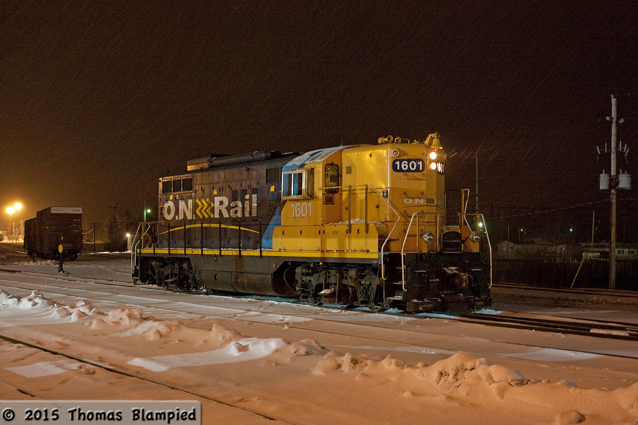 Living in the Toronto area, the idea of a snowstorm in late April is quite novel. In northern Ontario, however, inches of snow on the ground in the spring is nothing unusual. As snow and ice pellets fall, 1601 idles in front of Cochrane station as it waits to switch the stock from the incoming southbound Polar Bear Express.