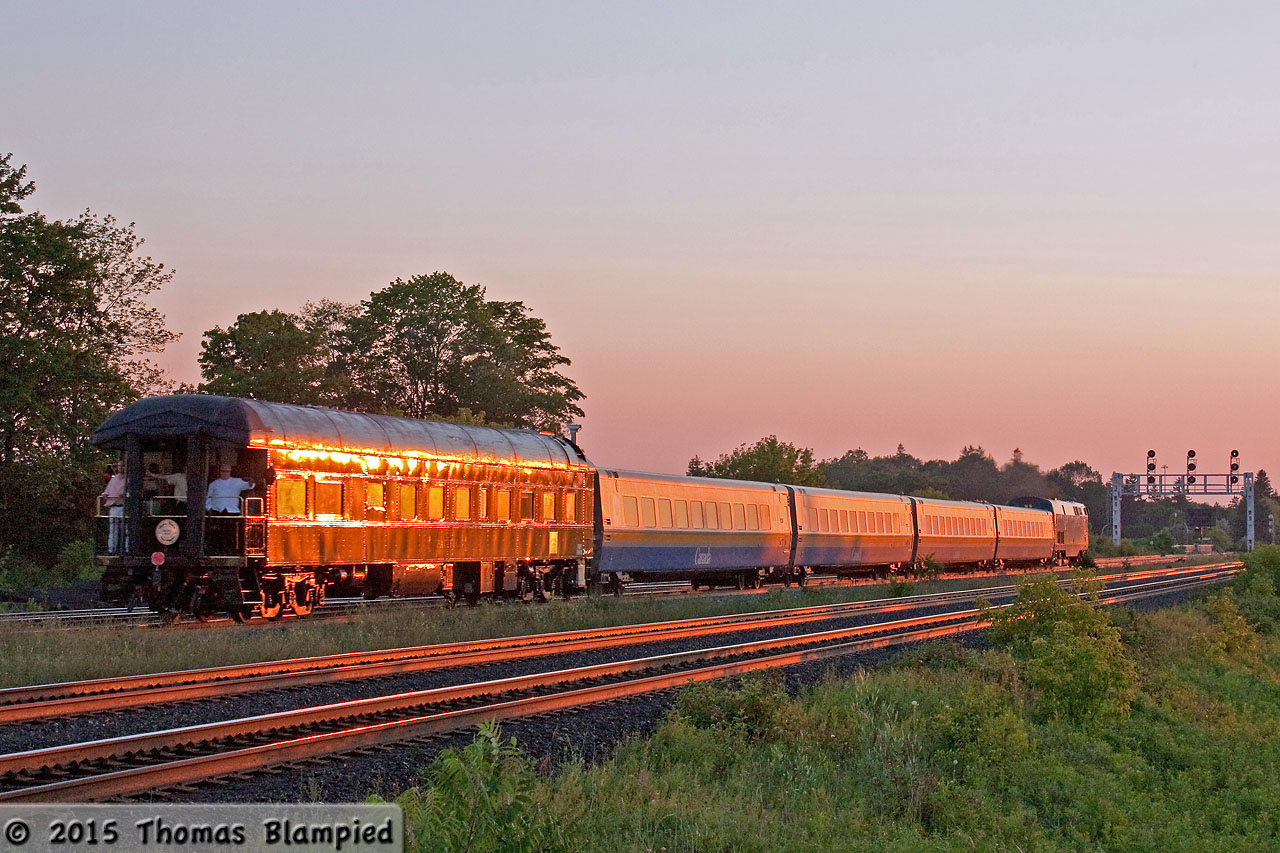 During the summer and fall of 2012, Mother Parkers celebrated their centennial with a series of charters using their private car, Pacific. The car was coupled to the end of VIA and ONR trains for a series of trips around Ontario and Quebec. The trips were limited to a wealthy clientele, who paid for the privilege of being pampered aboard the vintage car. Do not despair, however, all of this money and privilege went to good use as the trips were designed to raise money for the Alzheimer Society of Canada. In all, Mother Parkers aimed to raise $1 million. I don't know if they reached their goal, but Pacific's travels made 2012 a memorable year for railfans.

In this image, Pacific is seen on the tail of train 59 as is races through Whitby during the last minutes of sun.