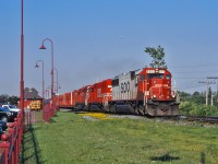 SOO 6003, SOO 746 and a CP SD40-2 lead train 421 westwards by the Beaconsfield AMT station in the middle of rush hour.  Once such a common sight, the SOO SD60s have become a treat to see in 2015.