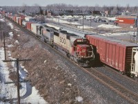 SOO 6026 and StL&H 5448 guide a hotshot intermodal train towards the Port of Montreal, as a manifest train works westward towards Smiths Falls.