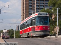 A route 506 streetcar climbs the bridge over the Danforth GO station.