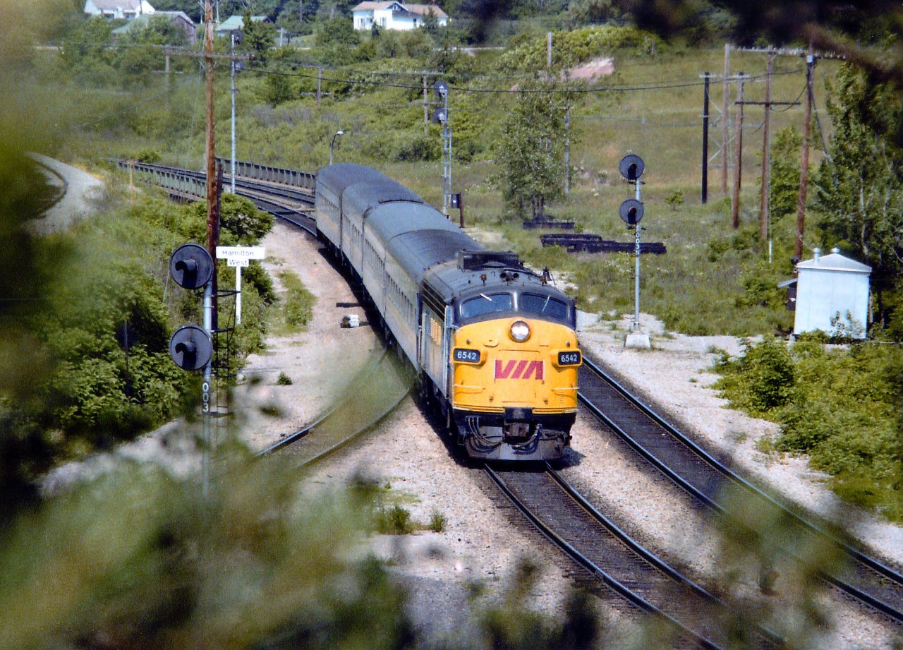 The sun is already high up as VIA 6542 moves smartly along on its way to an 1155 arrival at Toronto. Bridge in background spans Hwy 403.
