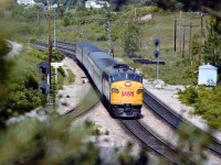 The sun is already high up as VIA 6542 moves smartly along on its way to an 1155 arrival at Toronto. Bridge in background spans Hwy 403.