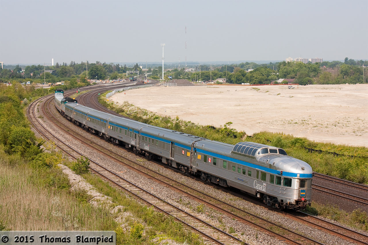 VIA 6457 pulls train 61 en route to Toronto. Tacked on the back, 6405 is in charge of the  Full Flex Express  with Waterton Park on the tail end. Rather than stick to the normal private jet or tour bus, electronic artist Skrillex opted to cross Canada by train instead. In 2012, Skrillex also crossed the country by rail, but the train ran under its own power throughout. So far, the train has travelled from Ottawa, to Montreal and now to Toronto as a "J" consist with a regularly scheduled train. Thanks to  Eric Gagnon  for confirming that train 61 was doing the honours today.