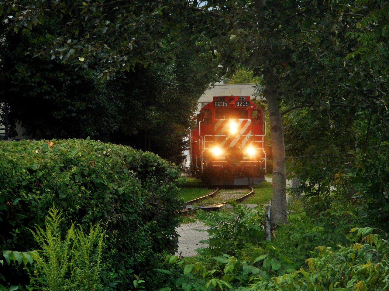 OSR GP9u 8235 (1958) and SW1200RSu 1210 (1958) roll south through downtown Guelph with 14 cars.