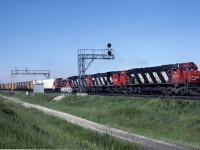 A followup to this posting of the same train at Bayview. http://www.railpictures.ca/?attachment_id=20447
I have the slide labeled as 'North of Toronto".  Pretty sure it is before the train would have entered Mac yard.  Maybe someone will recognize a landmark and fill in the details.  The 3 reefers that were first out behind the power at Bayview had been set off before getting to this point. (and the skies cleared rather nicely)