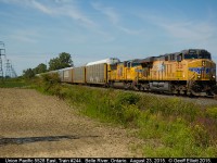 Looking like a shot taken in Illinois or Iowa, UP 5528, and sister 5054, lead Canadian Pacific train #244 through Belle River on August 23, 2015.