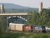 I am standing on a hillside with a long lens - over looking Cootes Paradise in the only clearing in vegetation around...CP 254 works its way through the crossovers at Desjardins after descending the escarpment in the background of the photo...shot about 630 pm. 
