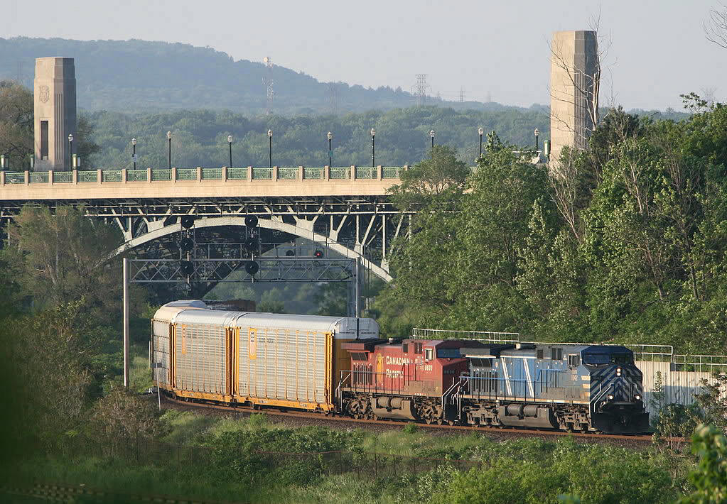 I am standing on a hillside with a long lens - over looking Cootes Paradise in the only clearing in vegetation around...CP 254 works its way through the crossovers at Desjardins after descending the escarpment in the background of the photo...shot about 630 pm.