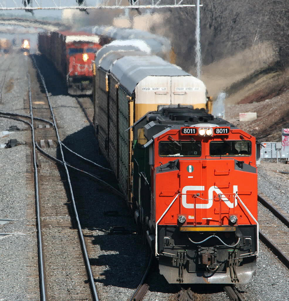 Three CN Auto related trains - now all history....  In the first couple of years since track 3 opened in 2006, It seemed to get it's fair share of usage.  Here -  CN train 271 - solid autos from the GM assembly plant in Oshawa bypasses stopped train 431 - which was parts cars from Oakville/Aldershot to the Ford stamping plant in Woodlawn NY ( South Buffalo )  The approaching headlight is CN 333 which originated in Oakville with finished autos and some miscellaneous traffic for CSX.  All 3 trains no longer exist -  271 died shortly before the recession and the subsequent closing of one of the Assembly plants,  333 and 431 morphed into today's 421.