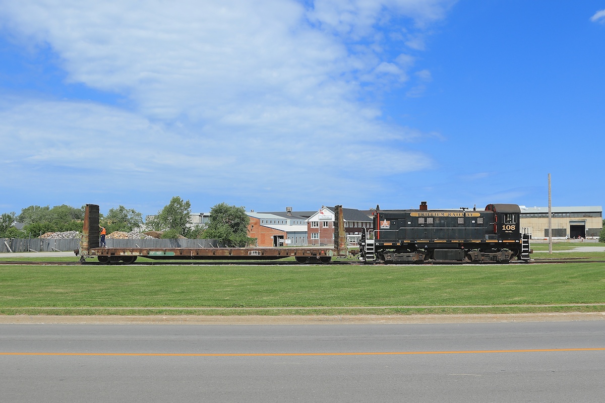 After delivering a load of steel plate for TIW Steel Plateworks, TRRY 108 pushes an empty flatcar back towards the NS&T Spur where they will reattach to the rest of her train.  In the background is the Trenergy factory, a local industry that is fabricating and assembling shells for the new DOT-111 (CTC-111A) tank cars.