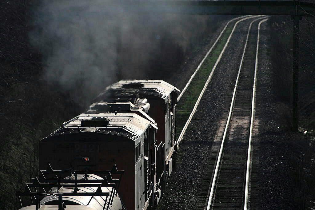 It's an unusually hot spring day...Saturday April 28th 2007....and standing on the bridge here you could smell the creosote rising from the ties......331 had made a big lift....and now was struggling out of the cowpath with allot of steel products.....two 2400's spliced by a 5300 standard cab Sd40 head west into the sun.