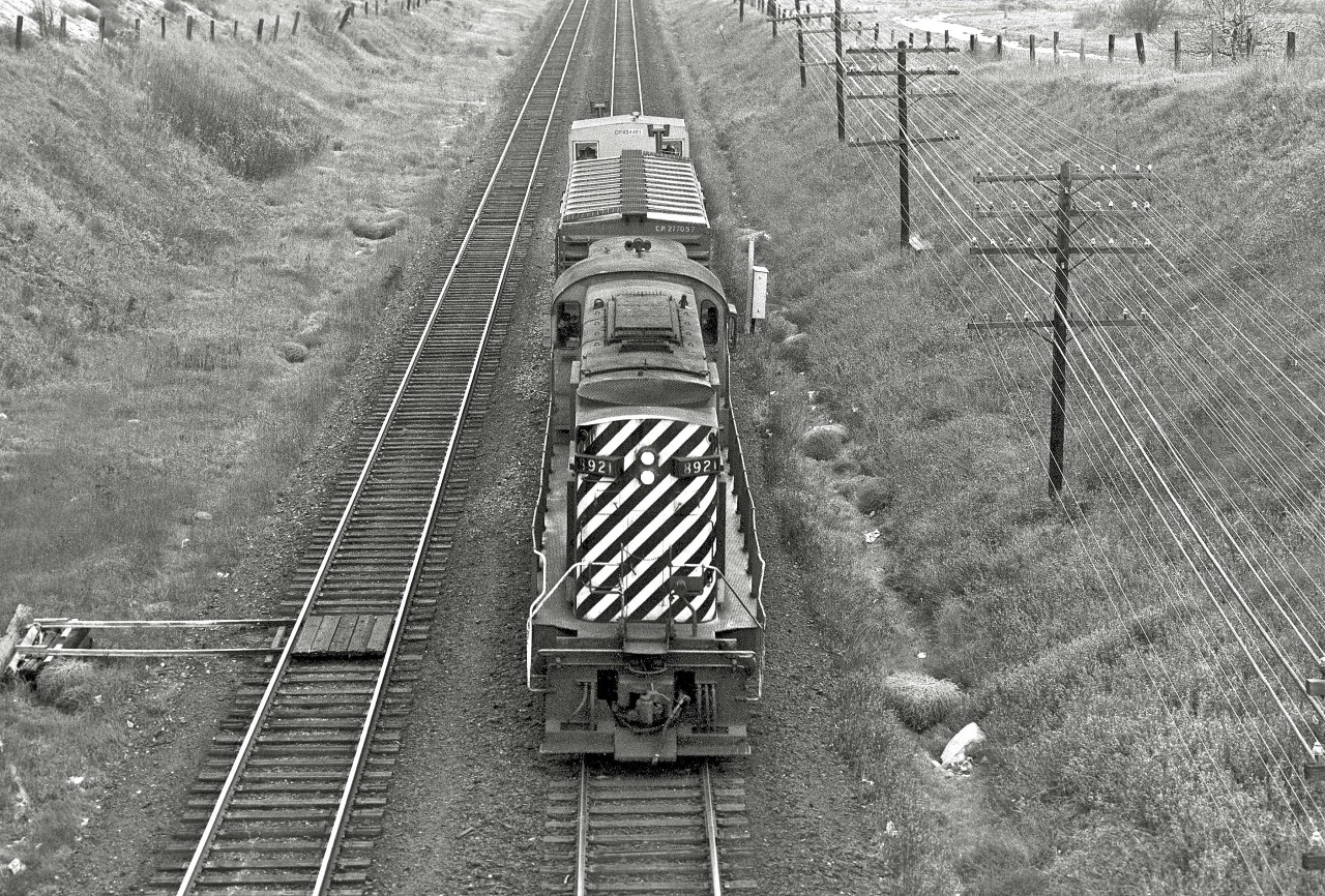 With the light shimmering on the power lines, the “Empress of Agincourt” runs light and fast on the Belleville Subdivision. 


It was nice to see Rob Smith’s recent shot of 8921 at the Elgin County Museum.   It reminded me of this photograph I snagged about forty years ago, circa 1975.  The location was the Victoria Park bridge in Scarborough.  I’ve previously posted some other images from this spot.  Shown here, the open land on the right later filled with townhomes.  On the left were the fields behind City Pontiac Buick.  This was my stomping grounds when I was growing up - acres and acres of fields, swamps, tree-forts and bulrushes.  When I returned a dozen or so years ago, it held a yellow grocery store and a strip plaza.  I’m thrilled that the Empress found a good home!


Look at this image carefully and you’ll spot all four crew members!


Check out Rob’s great shot…


http://www.railpictures.ca/?attachment_id=20247