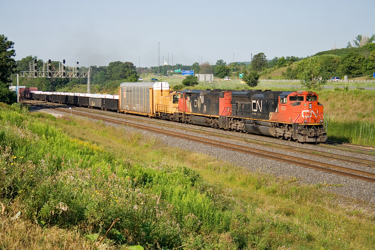 CN 384 eases off the Dundas Sub and throttles up for their climb towards Aldershot with CN 8804, CN 2447 and CN 1394 providing the power.  CN 1394 is an SW1200RS painted yellow, without any CN markings on it; the unit spent several months in Chicago and has returned to Mac Yard.