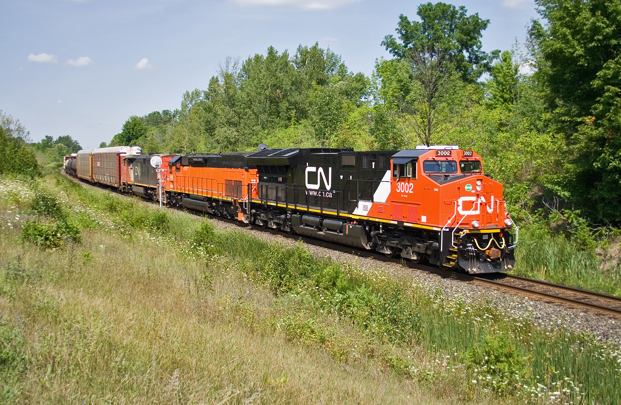 Brand new ET44AC 3002, BLE 910 and CN 2433 guide 435 down the Niagara Escarpment, with 11513 feet pushing on the drawbar.  435 will meet 422 at Tansley, another monster train with 11592 feet of traffic for Mac Yard.  3002 is one of two ET44ACs roaming the CN system (3 more being delivered on the 17th) and had a GE rep on board to monitor the units performance.